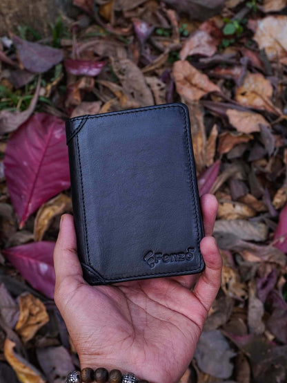 Handheld shot of Fenzo classic black genuine leather vertical trifold wallet with embossed brand logo